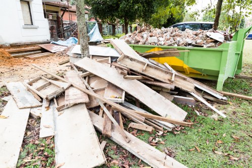 Home clearance team organizing furniture in a South West London home